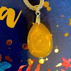 Handmade 17” silver tone necklace with sparkly yellow resin pendant.